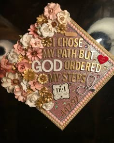 a graduation cap with flowers on it and the words i chose my path but god ordered my steps