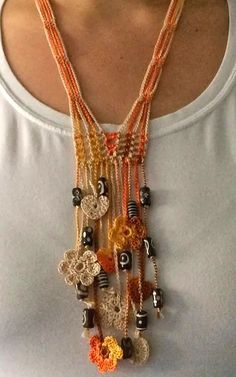 a woman wearing a necklace with beads and charms