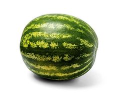 a large green watermelon sitting on top of a white surface