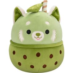 a green stuffed animal with brown spots on it's face and ears, sitting in front of a white background