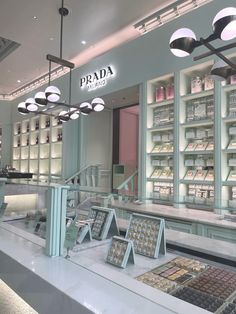 the inside of a cosmetics store with many items on display in front of glass shelves