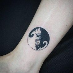 a cat and moon tattoo on the ankle is shown in black and grey ink,