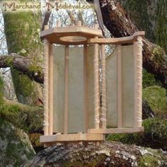 a wooden bird feeder sitting on top of a tree