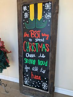 a chalkboard sign that says the best way to spend christmas is singing loud for all to hear