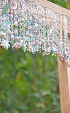 a wooden structure with beads hanging from it