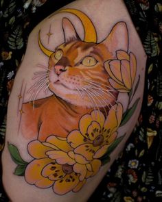 a cat with horns and flowers on it's thigh