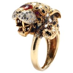 A vintage 18 karat yellow gold and gem-set cheetah ring. This ring features a cheetah head motif with black and white enamel detailing, set with single cut diamonds for whiskers and ruby eyes. A unique ring that will stand the test of time! Stones: - diamonds, 22 stones - single cut round - 1.4 mm - approximately .18 total carats - rubies, 2 stones - round cut - 1.5 mm Ring Size 6.5 Width: 21.4 mm Weight: 11.70 dwts. Leopard Ring, Tiger And Bunny, Moustaches, Ruby Diamond, White Enamel, Unique Rings, Fashion Rings, Favorite Jewelry, Diamond Cuts