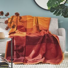 an orange and red blanket on a couch