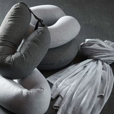 three pillows and two drawstring bags sitting on a table next to each other