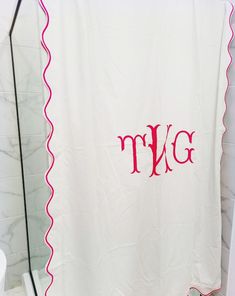 a monogrammed shower curtain in a bathroom