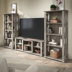 a living room with an entertainment center and bookshelves