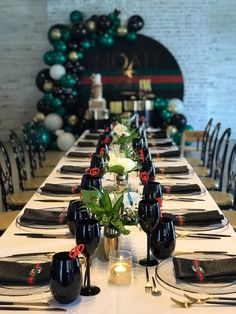 a long table set with black and white place settings