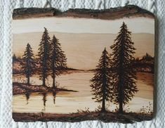 a piece of wood with trees painted on it