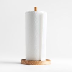 a roll of toilet paper on a wooden holder