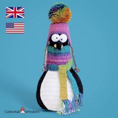 a stuffed penguin wearing a knitted hat and scarf