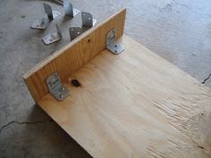 a piece of wood that has been made into a bench with metal brackets attached to it