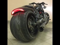 a motorcycle is parked on the floor with its rear tire turned upside down and it appears to be in need of repair