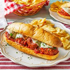 a meatball sub sandwich on a plate with chips