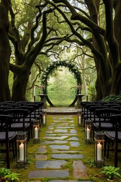 Step into a magical world with this 'Lord of the Rings'-inspired wedding venue set in an enchanting forest clearingSurrounded by towering ancient treesthis venue features a rustic wooden arch adorned with ivy and white flowersperfectly capturing the essence of Elvish eleganceThe stone pathwaylined with lanterns and leading to the ceremony spaceis flanked by dark wooden chairscreating a serene and timeless atmosphereIdeal for couples seeking a nature-inspiredfantasy-themed wedding that feels lik Faerie Themed Wedding, Dark Nature Wedding Theme, Elvish Inspired Wedding, Nature Wedding Venue Aesthetic, Forest Castle Wedding, Dream Mountain Wedding, Nature Venue Wedding, Weeping Willow Tree Wedding Ceremony, September Forest Wedding