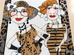 two women wearing leopard print dresses and hats