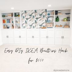 an empty room with lots of white cabinets and bookshelves on the wall, next to a carpeted floor