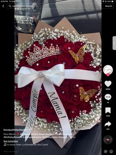 a bouquet of red roses in the shape of a heart with a tiara on top