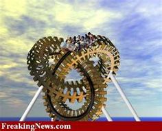 two people ride on the top of a roller coaster at an amusement park with blue sky and clouds in the background