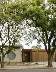 the house is surrounded by trees in front of it