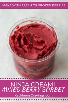 a bowl filled with red ice cream on top of a table