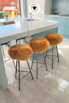 two stools that are sitting in front of a counter