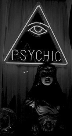 a neon sign that says psychic with an all seeing eye on it