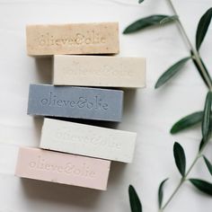 five soap bars are stacked on top of each other with the words olive and cookie