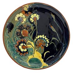 a black and yellow plate with flowers painted on it