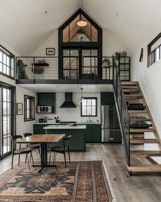 an open floor plan with stairs leading up to the loft