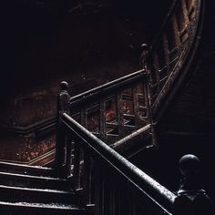 a person walking up some stairs in the dark