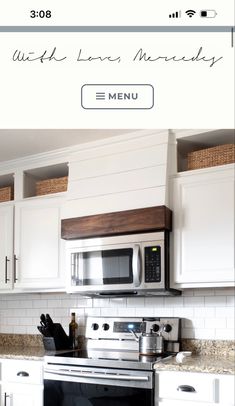 a kitchen with white cabinets and stainless steel appliances, including a silver stove top oven