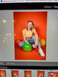 a woman is sitting on the floor with balloons in front of her and an orange background behind her