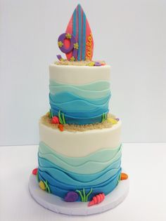 a three tiered cake decorated with an ocean theme