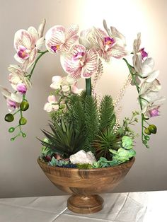 an arrangement of flowers in a wooden bowl