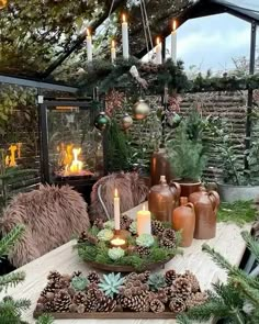 a table topped with lots of pine cones and candles