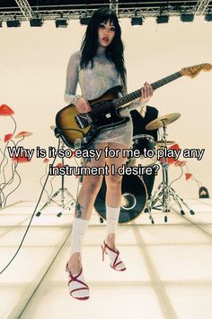 a woman in high heels is holding a guitar