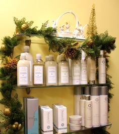 a shelf filled with lots of different types of skin care products next to christmas decorations