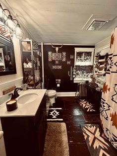 a bathroom with black and white decor on the walls, rugs and shower curtain