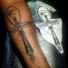 a person with a tattoo on their arm and an image of a cross in the background