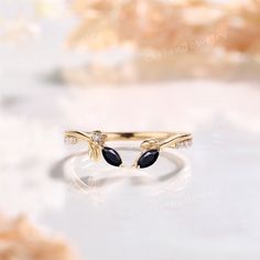 a gold ring with black and white stones