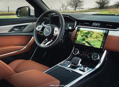 the interior of a car with an entertainment system and steering wheel view through the center console