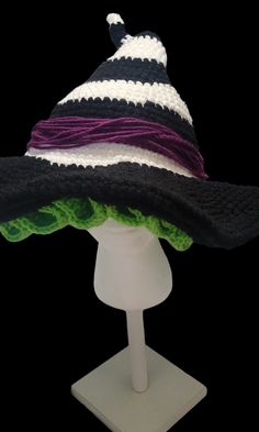 a black and white striped hat on top of a mannequin head