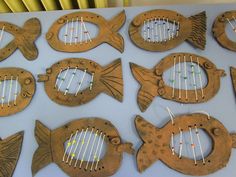 several wooden fish with strings attached to them