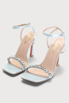 Go for glam in the Lulus Goldiena Sky Blue Satin Rhinestone Ankle Strap Heels! Sleek satin shapes these elegant heels that have a square footbed and a slender toe strap that's adorned with clear rhinestones in a variety of cuts. A matching strap wraps around and secures above the ankle with a silver buckle. Sculpted heel. 4" wrapped stiletto heel. Cushioned insole. Felted rubber sole has nonskid markings. Man made materials. Imported. Lulus | Goldiena Sky Blue Satin Rhinestone Ankle Strap Heels Sky Blue Wedding Shoes, Heels For Blue Dress, Powder Blue Heels, Pastel Blue Heels, Sky Blue Heels, Blue Wedding Heels, Light Blue Wedding Shoes, Baby Blue Heels, Light Blue Heels