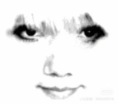 a black and white photo of a woman's face with the eyes wide open